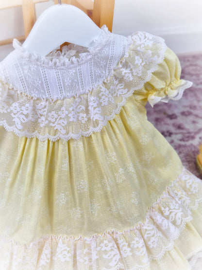 9-12 months. Lemon vintage Bryan dress with white lace bib, puff sleeves and frills