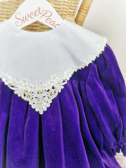2 years. Deep purple velour Bryan dress with white lace hem and bib with pearl details