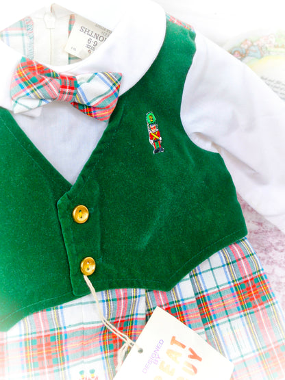 12 months. Vintage romper by Great Guy. Long sleeves, green velvet-like vest, tartan bottom and bow tie. Embroidered toy soldier and gold buttons