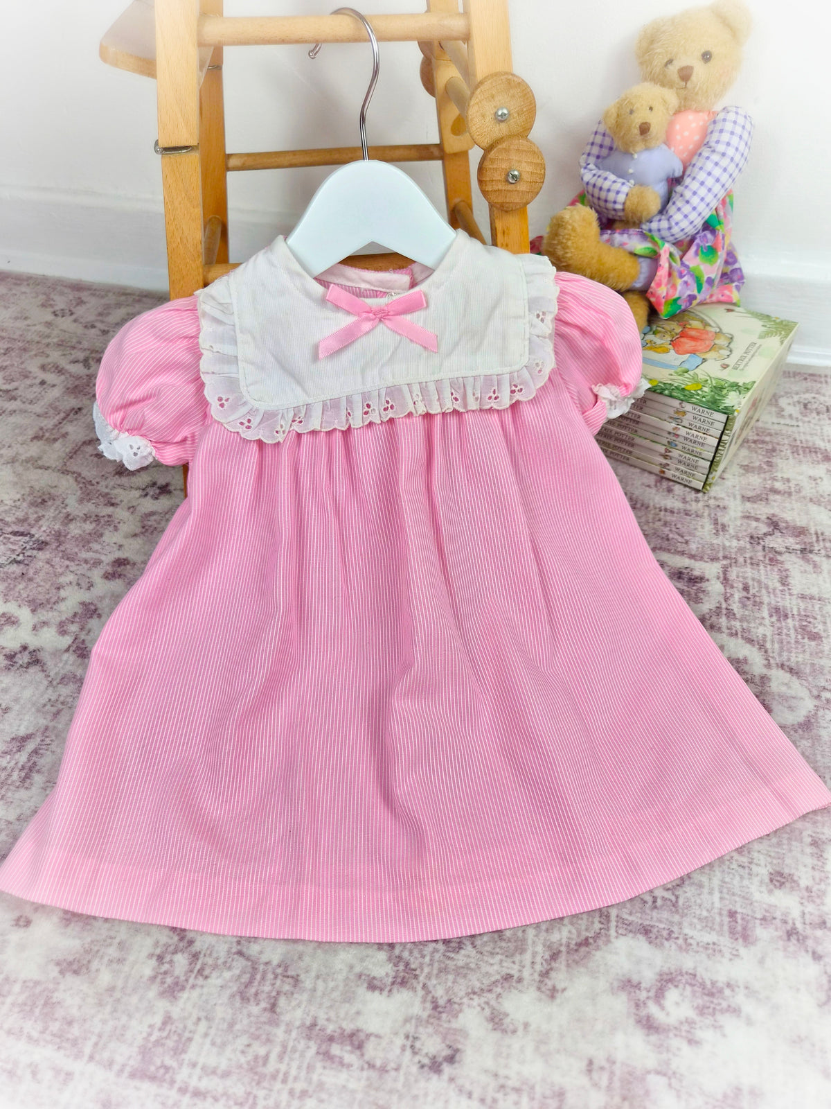 12-18 months. Pink and white striped vintage dress with white bib eyelet trim and pink satin bow