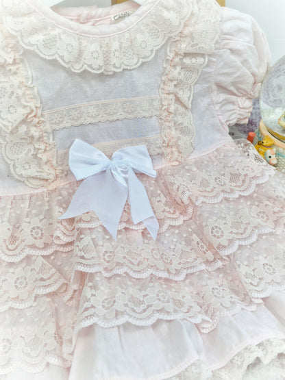12 months. Pink vintage frilly dress with lace ruffles, puff sleeves and white ribbon