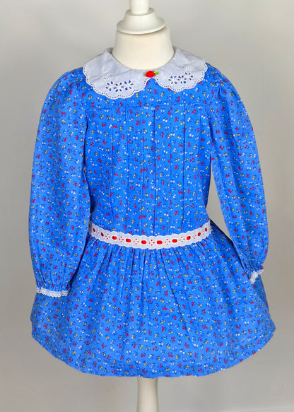 4 years. Blue vintage floral dress from Evy with white eyelet collar, red rosette and ribbon