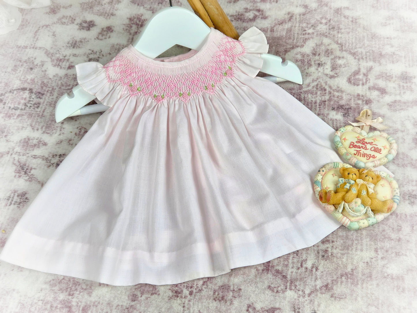 6 months. Vintage inspired pink smock dress with flutter sleeves and pink embroidery