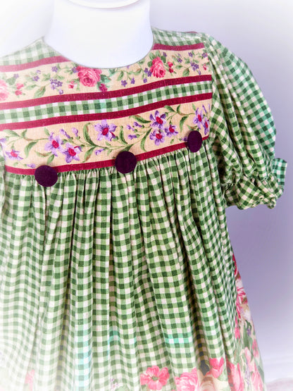 5 years.  Green and cream checked vintage dress with floral print and puff sleeves