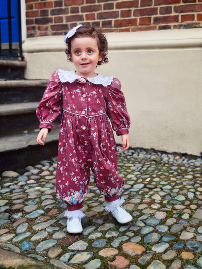 18 months. Vintage Daisy Kingdom romper, maroon with flowers, white collar and padded shoulders