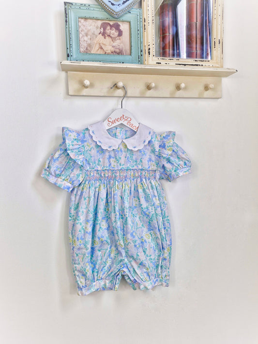 12-18 months. Blue, floral, smocked romper with white, embroidered collar