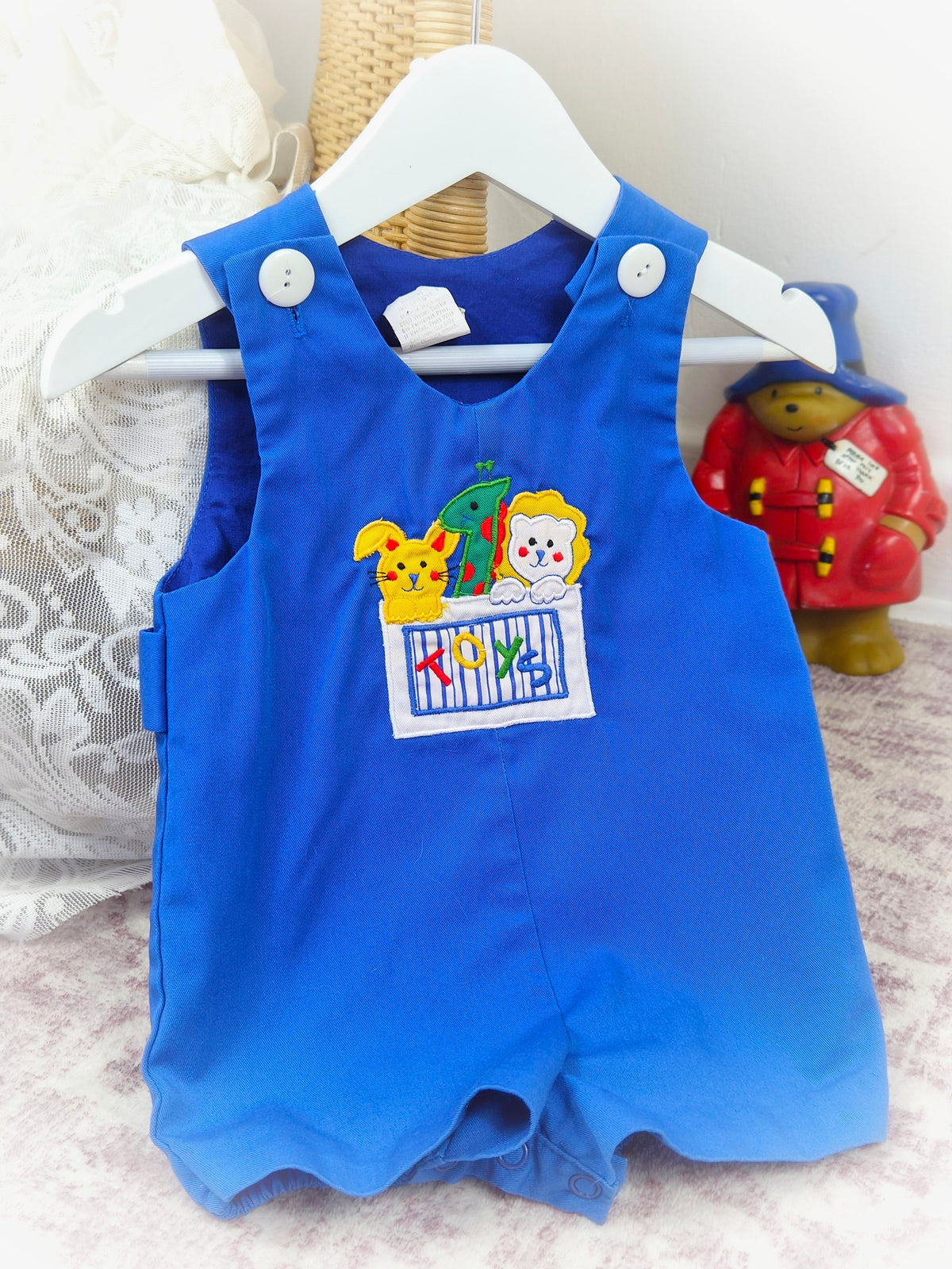 6-9 months. Royal blue romper with cute animals in a toy box