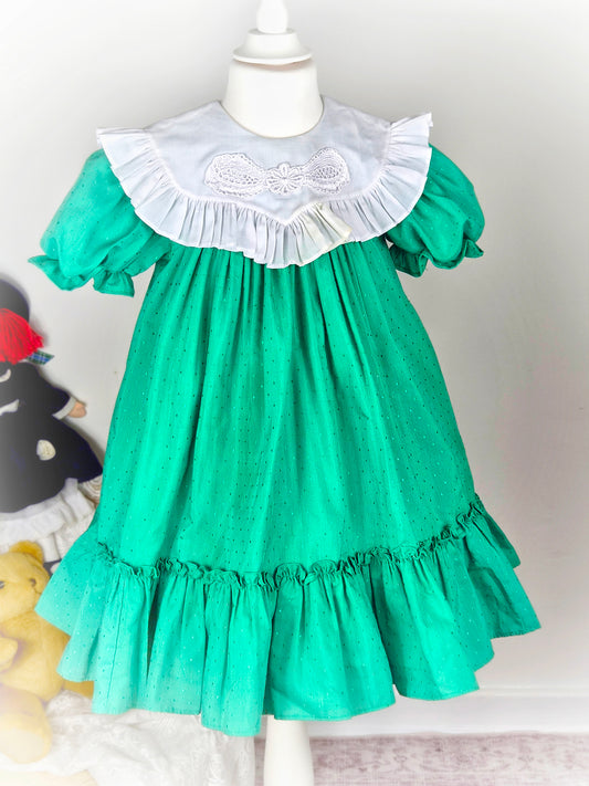 5 years. Green Vintage Mini World dress with white bib.