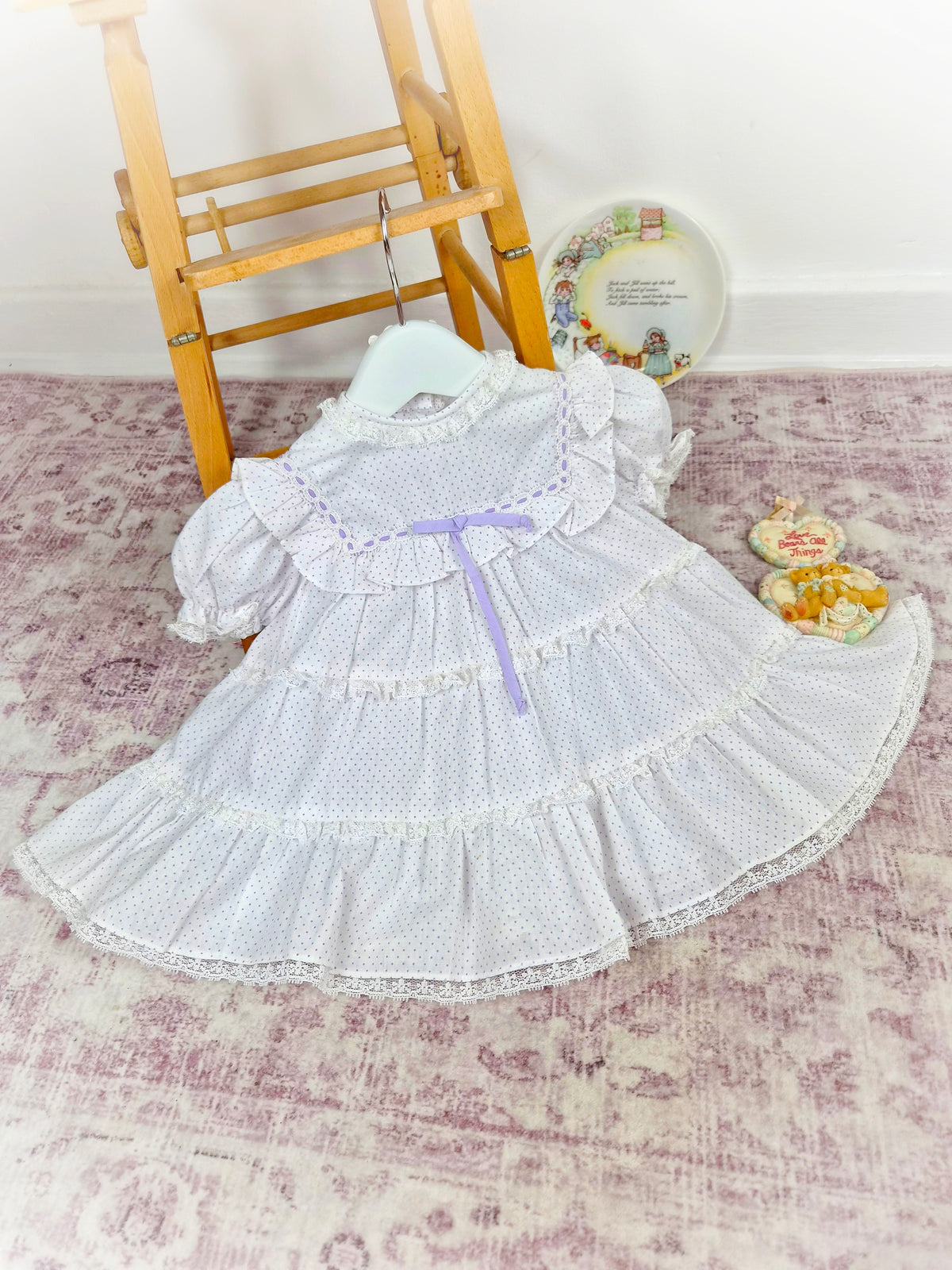 12 months. White vintage dress with lilac polka dots and ribbon, tiers and lace trim