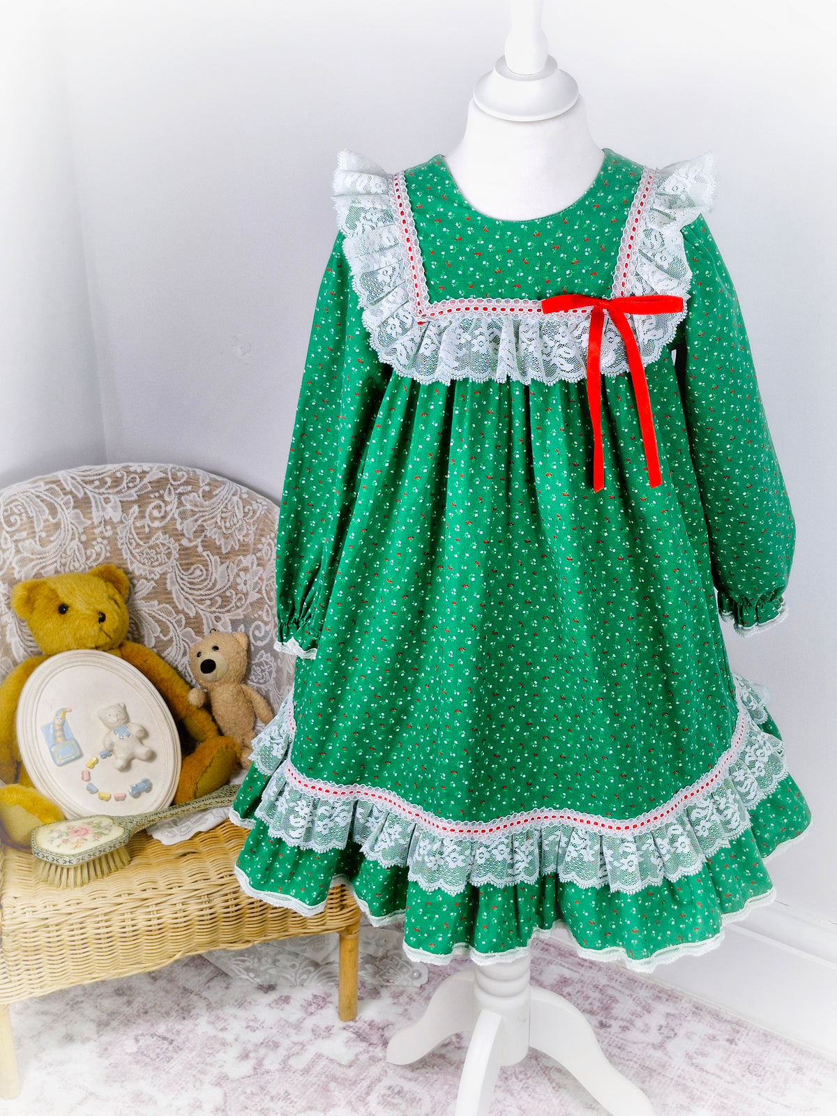 6 years. Green vintage Bryan with red and white floral print, white lace details and red ribbon