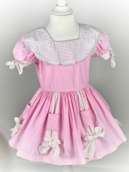 3 years. Pink vintage dress by Cotton Candy with white bib & bows and pink polka dots