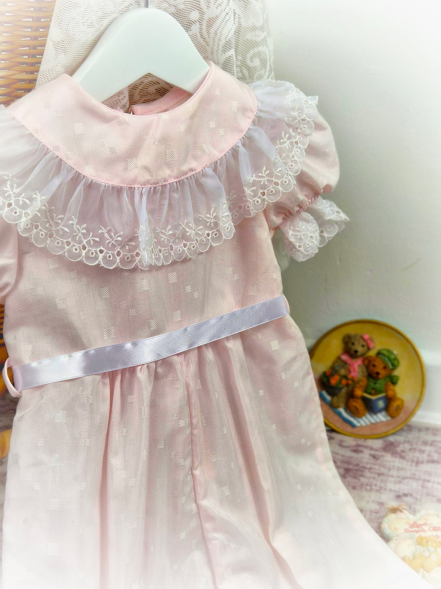 12-18 months. Pale pink vintage romper by I Am Erica with white lace bib trim and satin ribbon