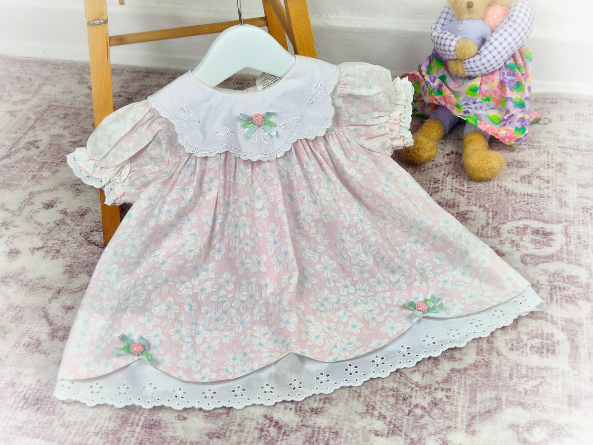 9-12 months. Pink and white floral vintage dress with embroidered details on the bib