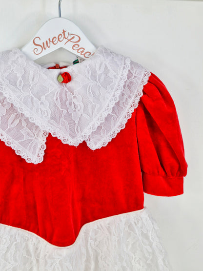 3 years. Red velour dress with white lace, double bib and skirt. Red rosette.