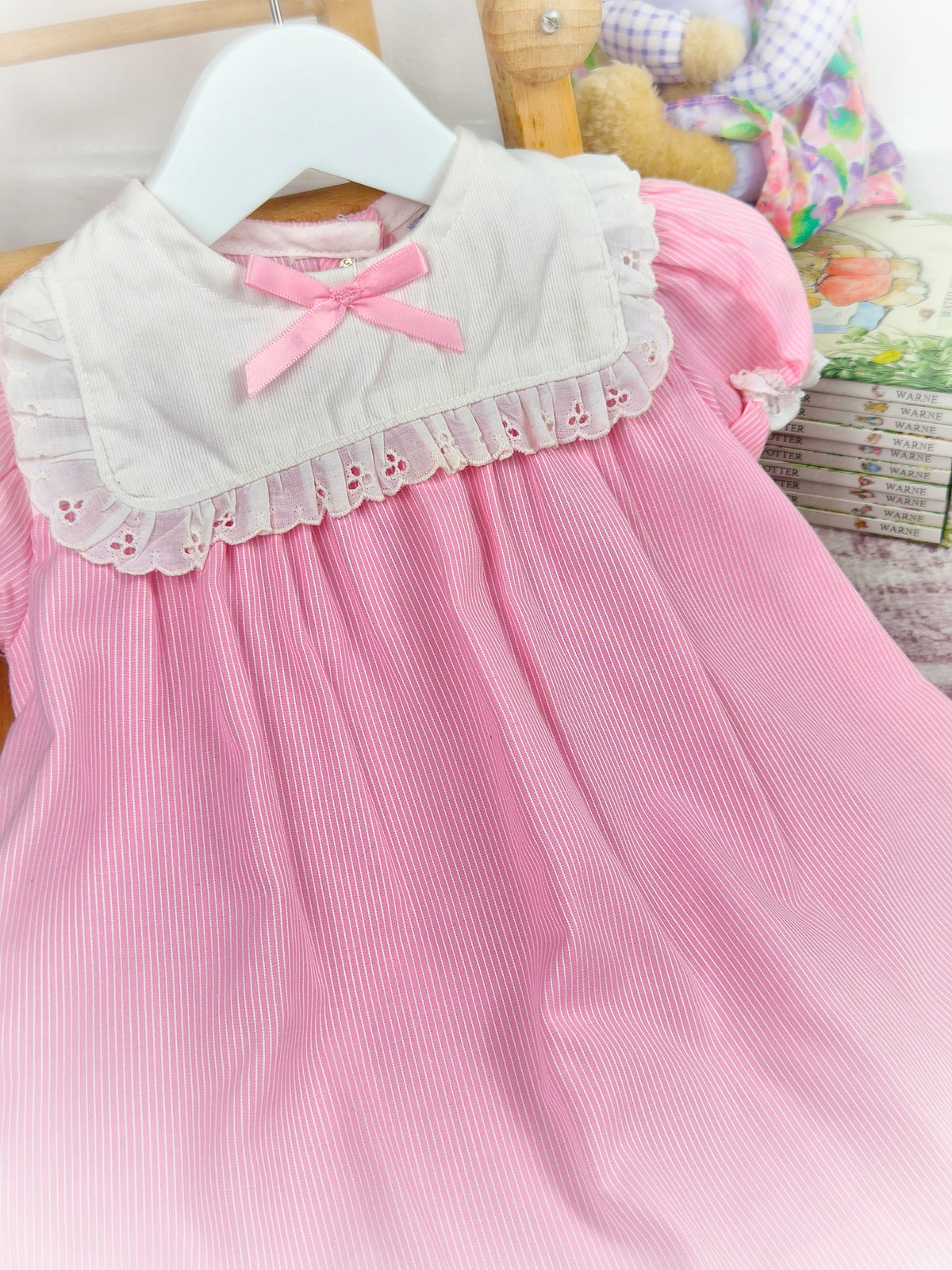 12-18 months. Pink and white striped vintage dress with white bib eyelet trim and pink satin bow