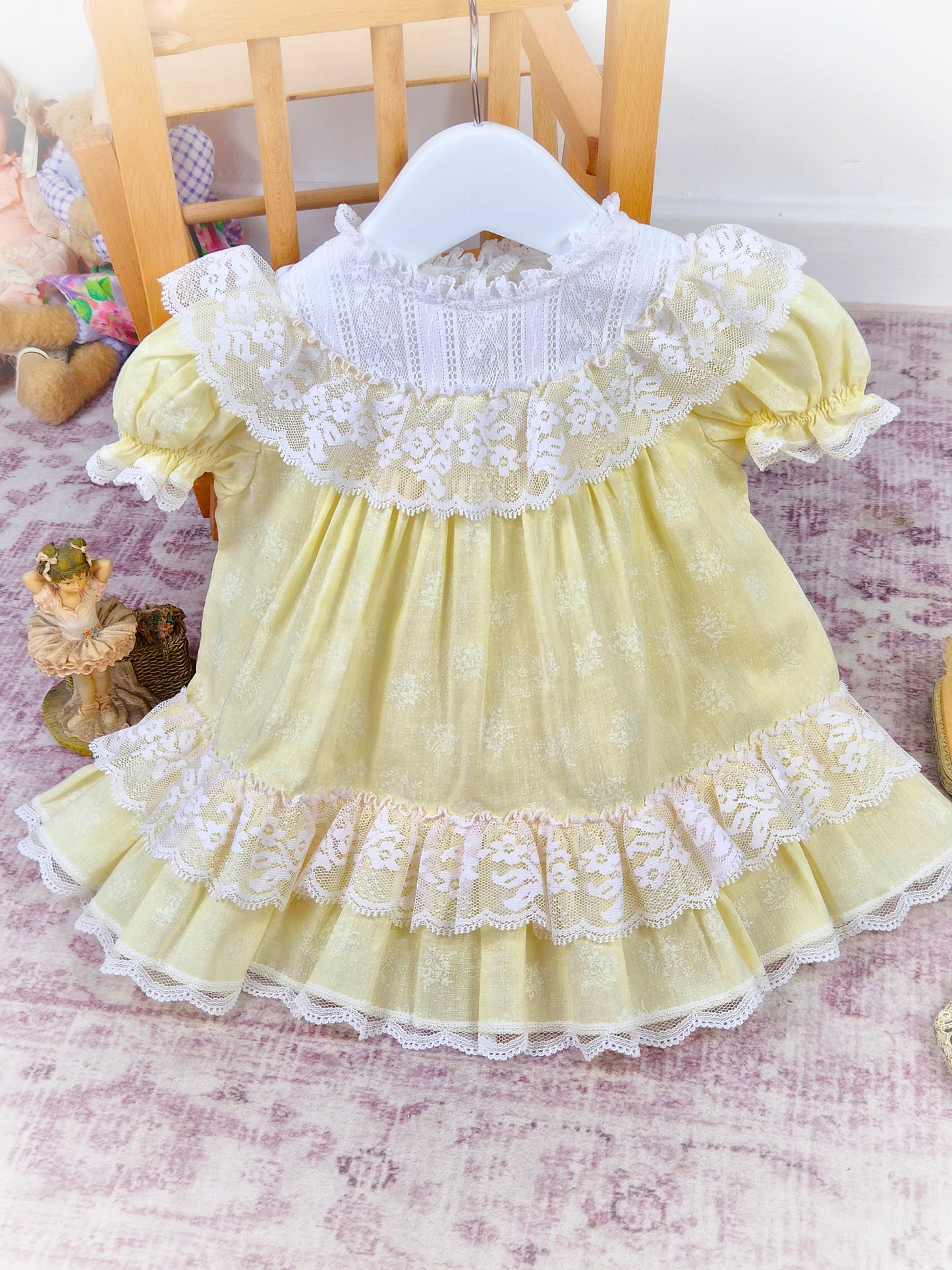 9-12 months. Lemon vintage Bryan dress with white lace bib, puff sleeves and frills