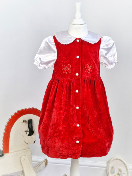 6 years. Red velvet dress with while silk collar and sleeves. Bow/Rose details, pearl buttons
