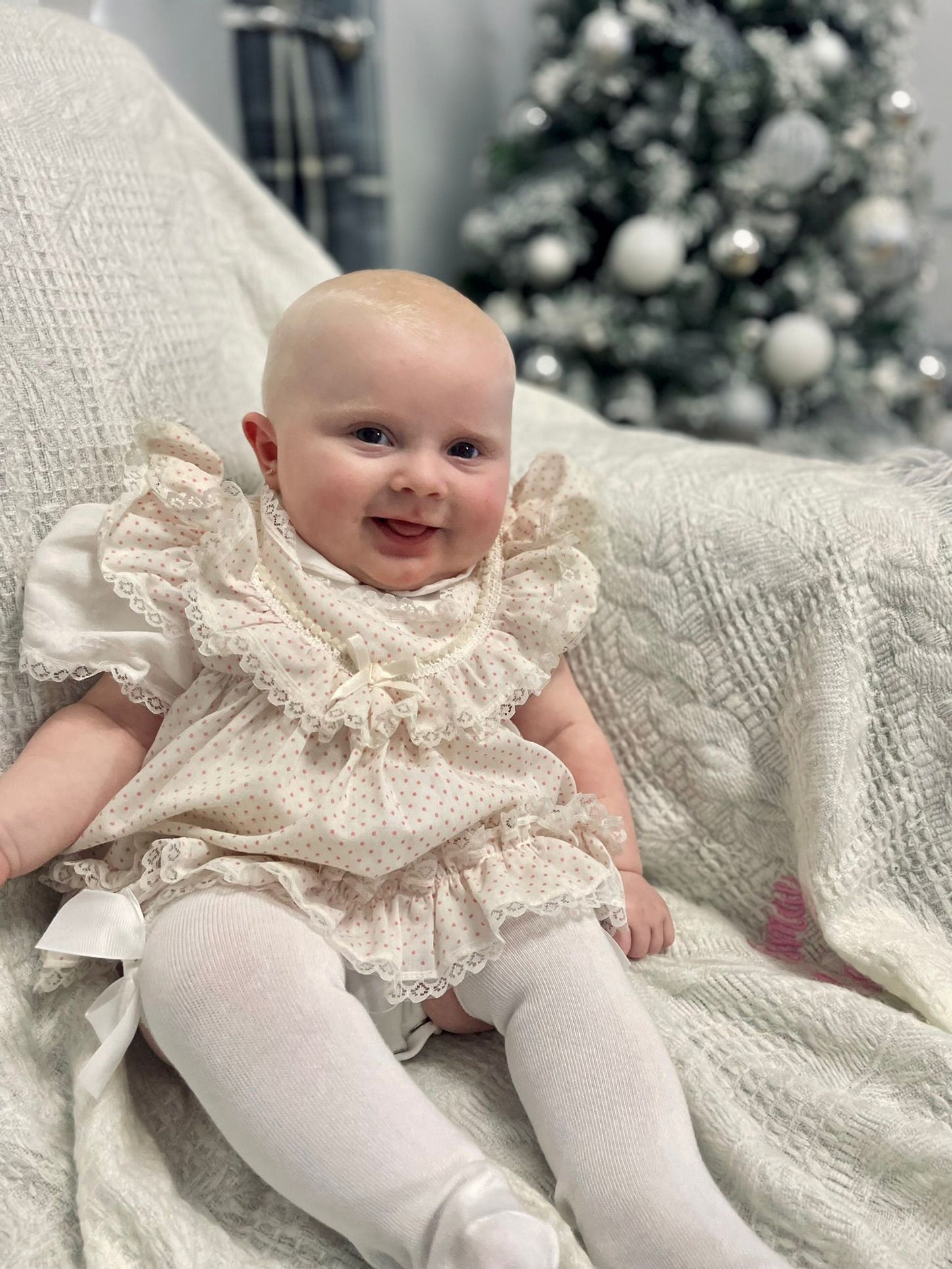 6-9 months. White frilly dress with pink polka dots