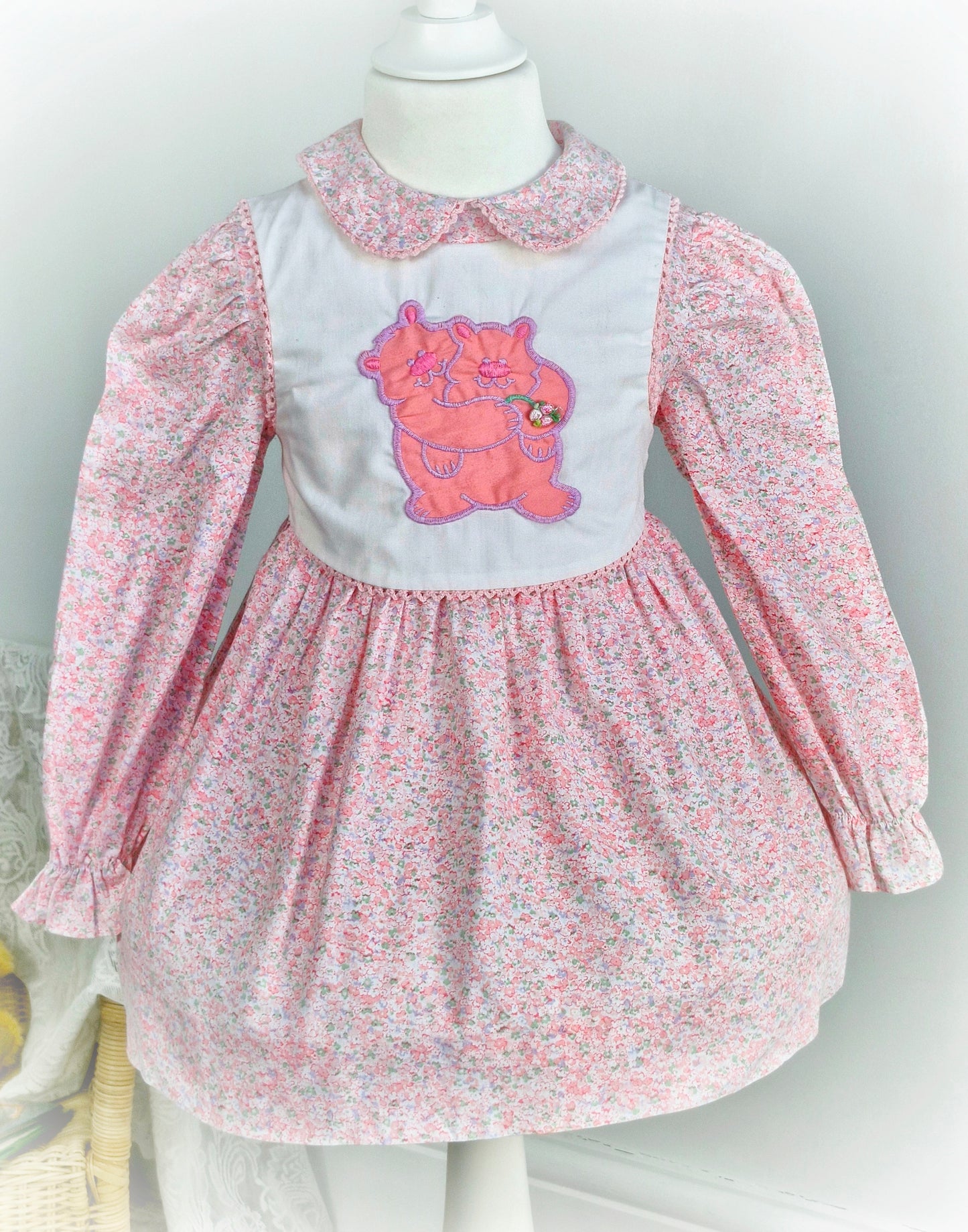 3 years. Pink floral vintage Polly Flinders dress with white bib featuring a bears applique
