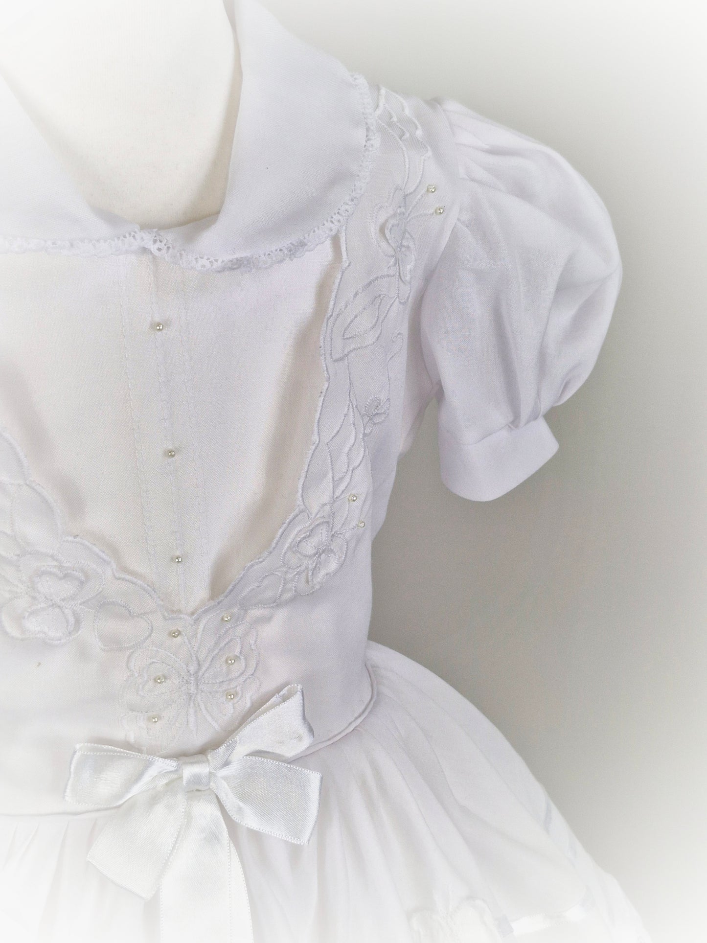 6 years. White dress with ribbon and butterfly details.