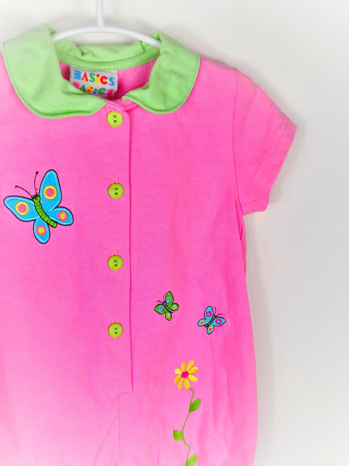 9-12 months. Pink romper with green collar and buttons, embroidered butterflies and flowers