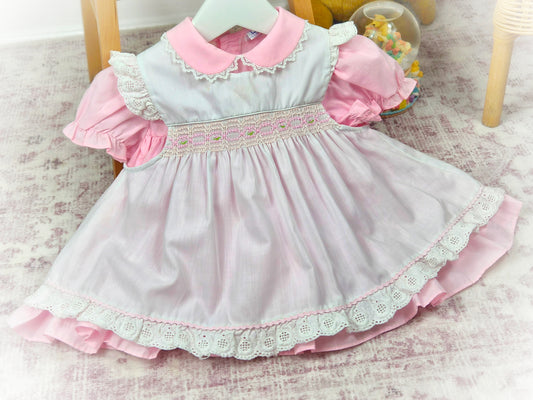 9-12 months. Pink vintage dress from Nana's Pet with white smocked apron, embroidered with pink details
