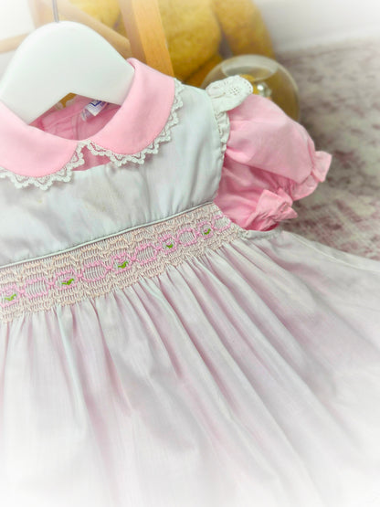 9-12 months. Pink vintage dress from Nana's Pet with white smocked apron, embroidered with pink details