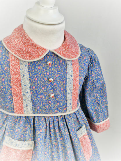 2-3 years. Floral dress with collar and rose buttons