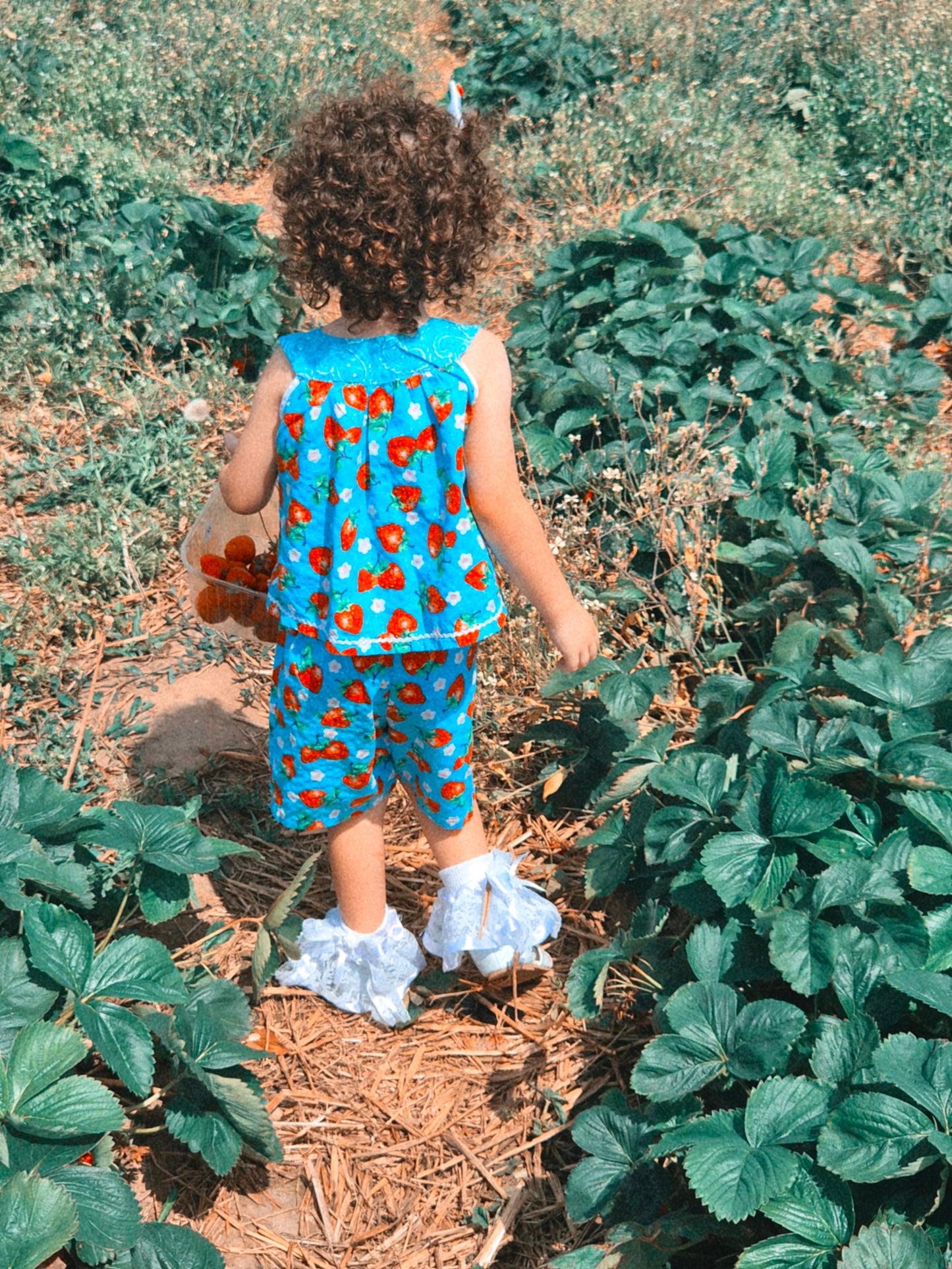 3 years. Two piece set, blue sleeveless top with matching shorts, strawberry print and dainty buttons