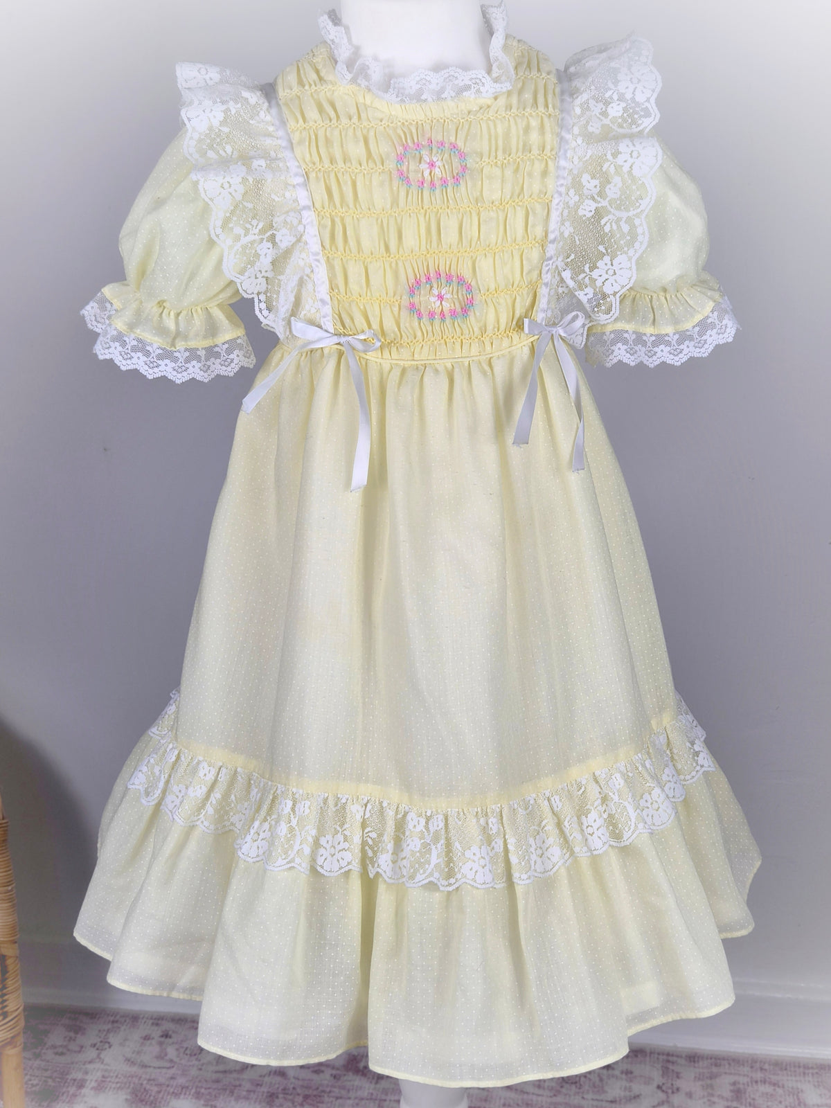 6-7 years. Lemon vintage smocked Polly Flinders dress with embroidered flowers, puff sleeves and lace trim