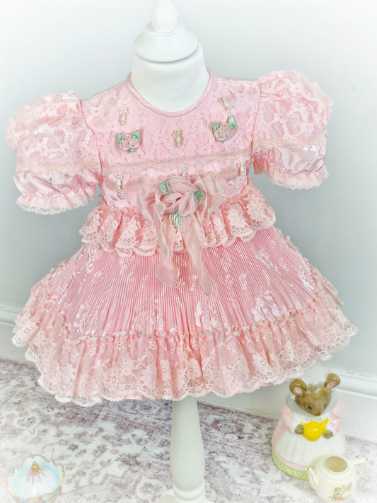 12-18 months. Pink frilly vintage dress with lots of details.