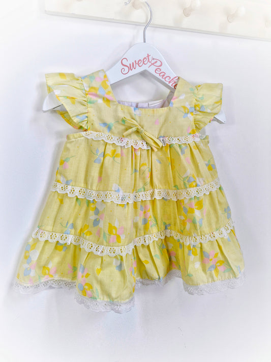 9-12 months. Lemon dress with flutter sleeves, floral print and lace details