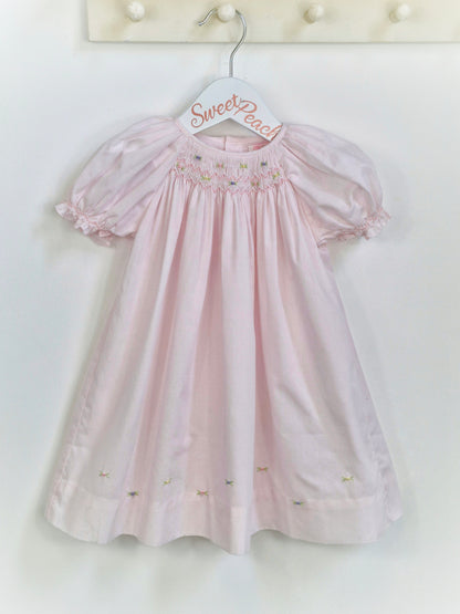 12 months. Petit Ami, pale pink gown with smocking and embroidery neckline
