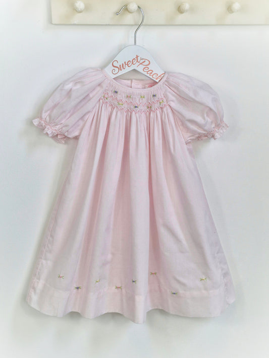 12 months. Petit Ami, pale pink gown with smocking and embroidery neckline