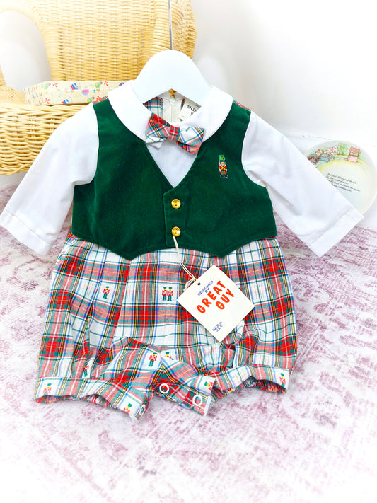 12 months. Vintage romper by Great Guy. Long sleeves, green velvet-like vest, tartan bottom and bow tie. Embroidered toy soldier and gold buttons