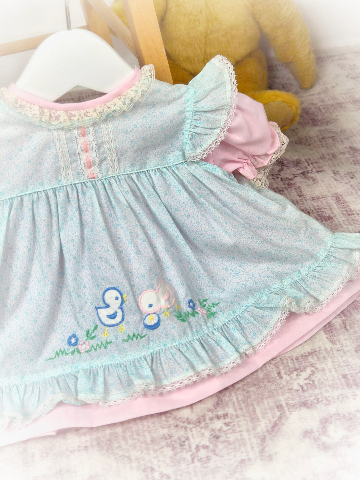 0-6 months. Pink vintage dress with blue apron. Flutter shoulders, embroidered chicks and frill hem