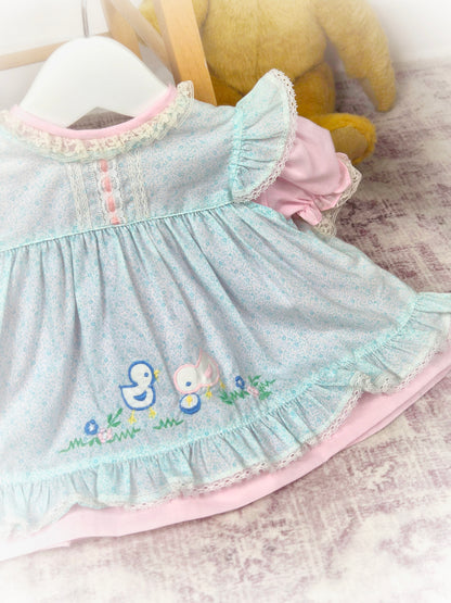 0-6 months. Pink vintage dress with blue apron. Flutter shoulders, embroidered chicks and frill hem