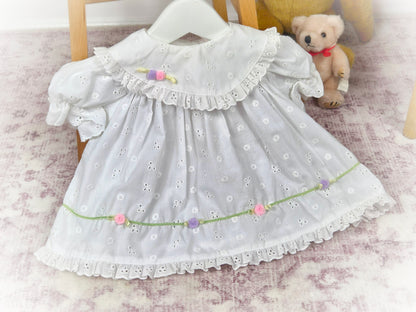 3-6 months. White vintage eyelet dress with frilly hem and dainty rosettes