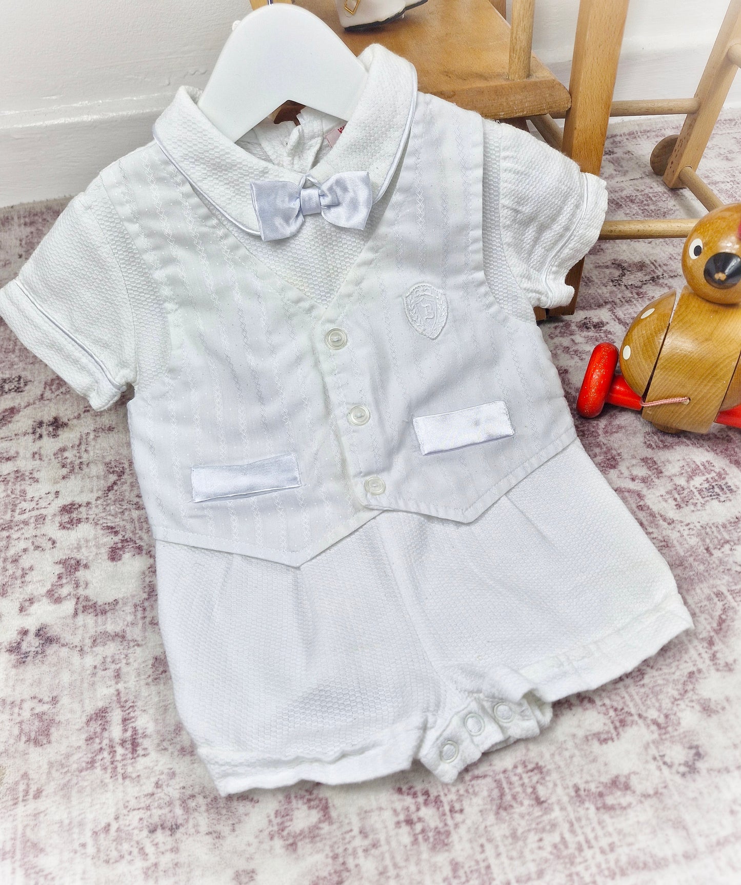 9-12 months. White one-piece romper, waistcoat and bow tie style