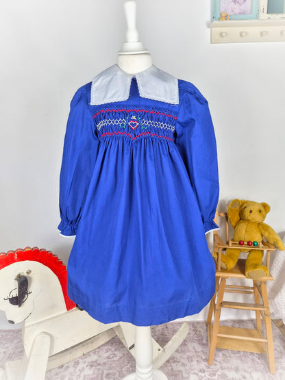 5-6 years. Royal blue vintage smock dress with embroidered heart and red design & white detachable collar. Princess Anne