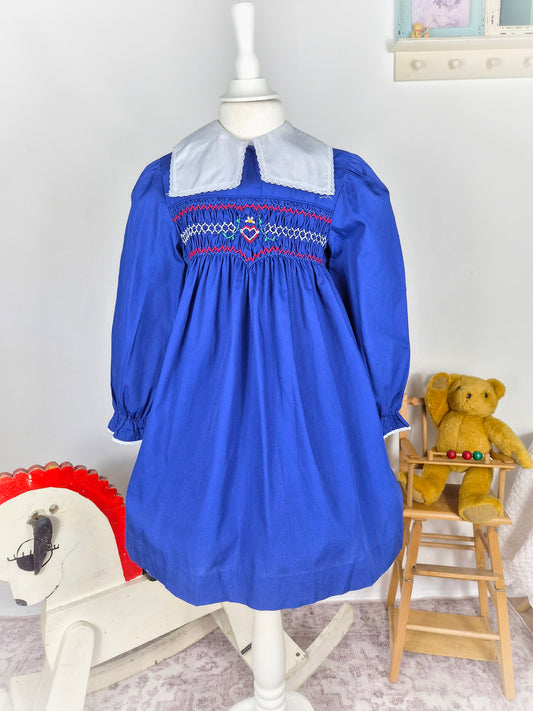 5-6 years. Royal blue vintage smock dress with embroidered heart and red design & white detachable collar. Princess Anne