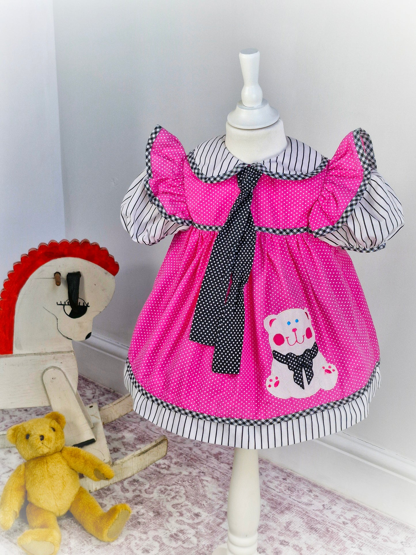 2 years. Pink, black and white vintage dress with bear applique and long neck tie