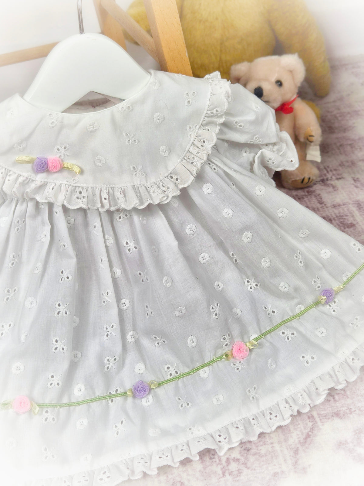 3-6 months. White vintage eyelet dress with frilly hem and dainty rosettes