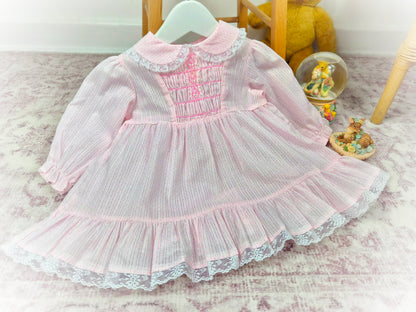 12-18 months. Pink vintage Polly Flinders smock dress with pink embroidery, stripes & spots and lace trim