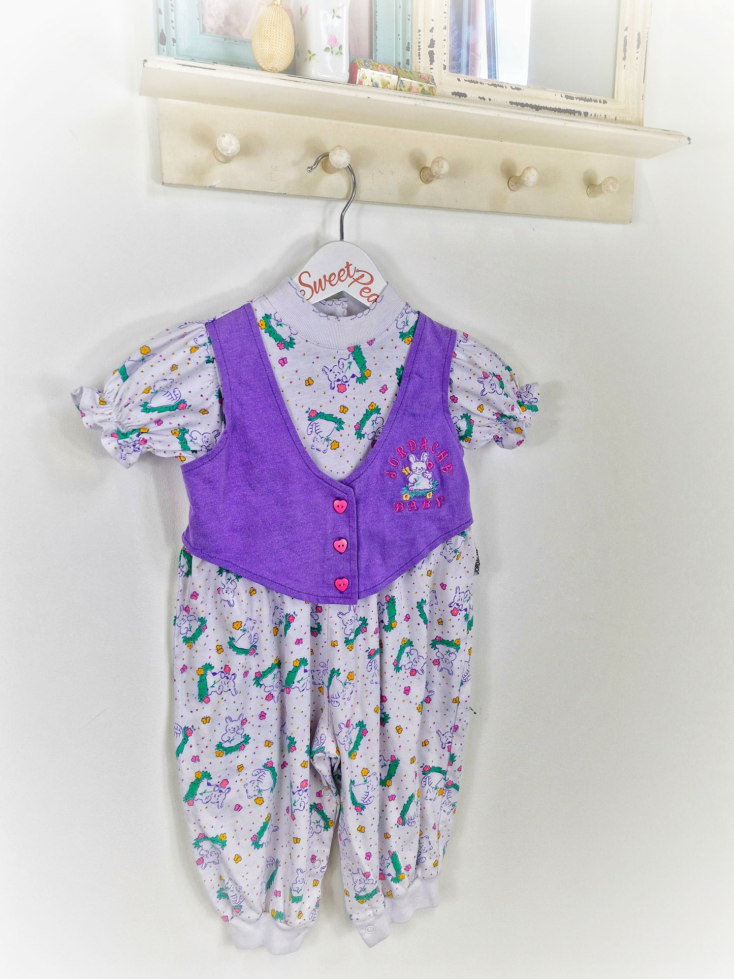18 months. Purple and white romper with rabbit prints and heart buttons