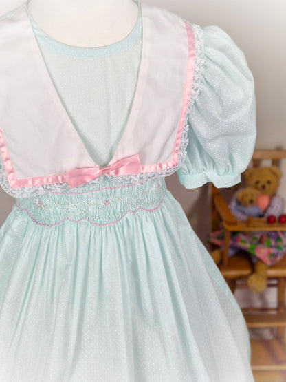 5 years. Mint vintage Polly Flinders smocked dress eith puff sleeves, white collar and pink satin ribbon