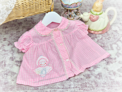 0-3 months. Pink and white lace trimmed, gingham vintage dress with little doll applique