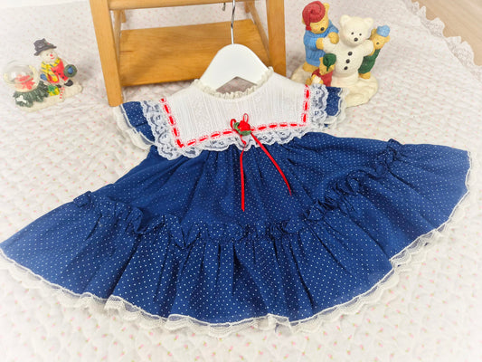 6-9 months. Navy blue polka dot vintage Bryan dress with white lace bib and red ribbon details