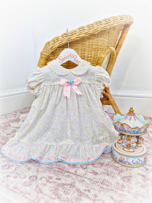 12-18 months. White collared dress with pastel hearts and ribbons from Lil' Airess
