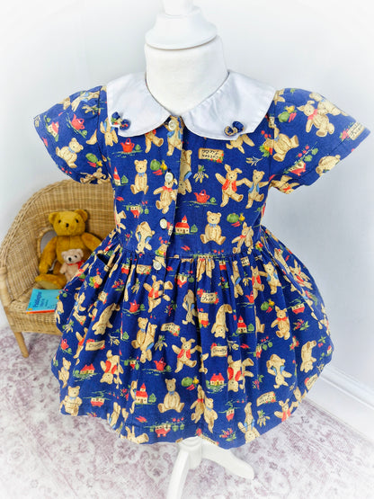 2 years. Vintage inspired navy dress with Peter pan collar featuring teddy bears & bunnies